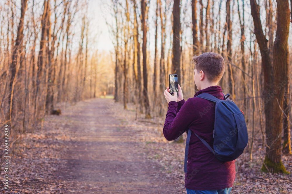 Child hiking in the woods and taking photos Child hiking in the woods and taking photos