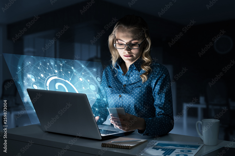 Beautiful blonde in dark office working on laptop and getting net access Beautiful blonde in dark office working on laptop and getting net access