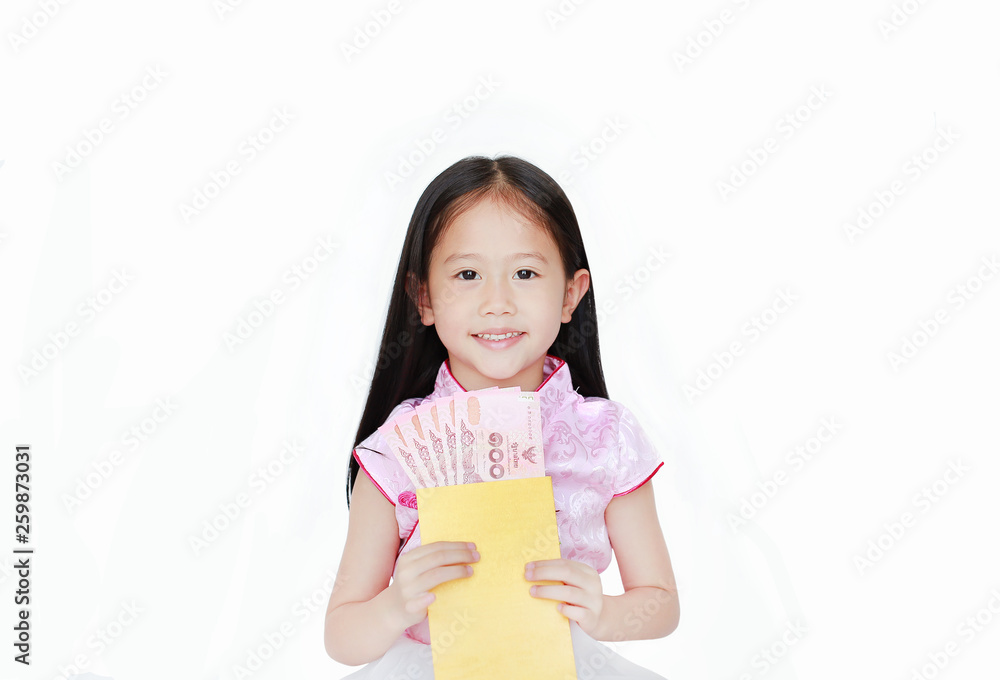 Happy little Asian child girl wearing pink traditional cheongsam dress smiling while receiving Chinese New Year gold envelope packet with money isolated on white background. Happy chinese new year. Happy little Asian child girl wearing pink traditional cheongsam dress smiling while receiving Chinese New Year gold envelope packet with money isolated on white background. Happy chinese new year.