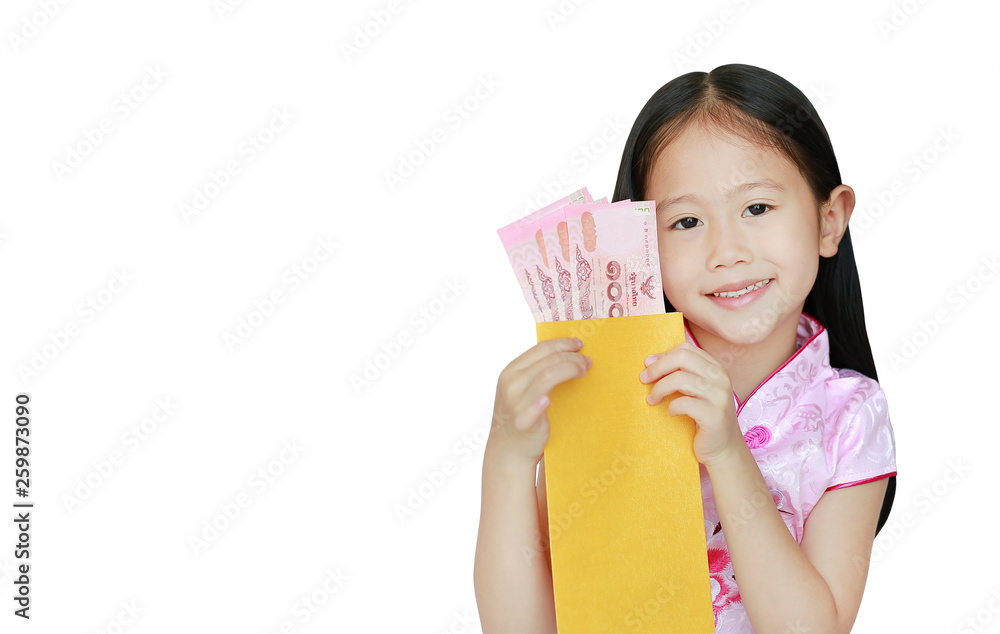 Happy little Asian child girl wearing pink traditional cheongsam dress smiling while receiving Chinese New Year gold envelope packet with money isolated on white background. Happy chinese new year. Happy little Asian child girl wearing pink traditional cheongsam dress smiling while receiving Chinese New Year gold envelope packet with money isolated on white background. Happy chinese new year.