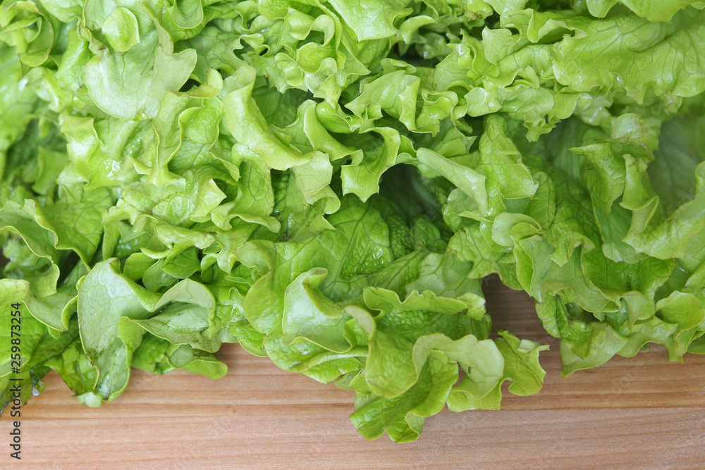 Green salad leaves on a wooden table Green salad leaves on a wooden table