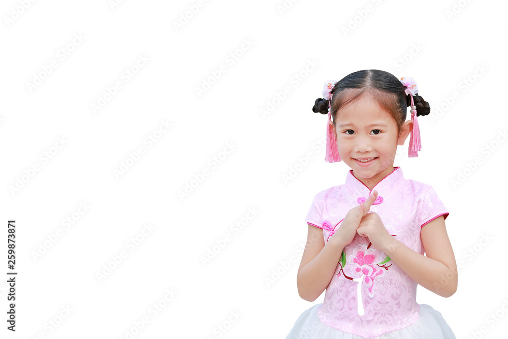 Happy little Asian child girl wearing pink traditional Chinese dress with greeting gesture celebration for Chinese New Year isolated on white background with copy space. Happy little Asian child girl wearing pink traditional Chinese dress with greeting gesture celebration for Chinese New Year isolated on white background with copy space.
