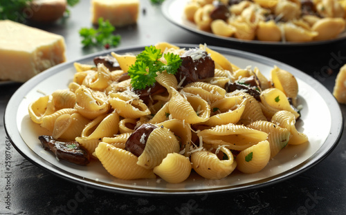 Conchiglie pasta with mushrooms, creamy sauce, parmesan cheese and herbs