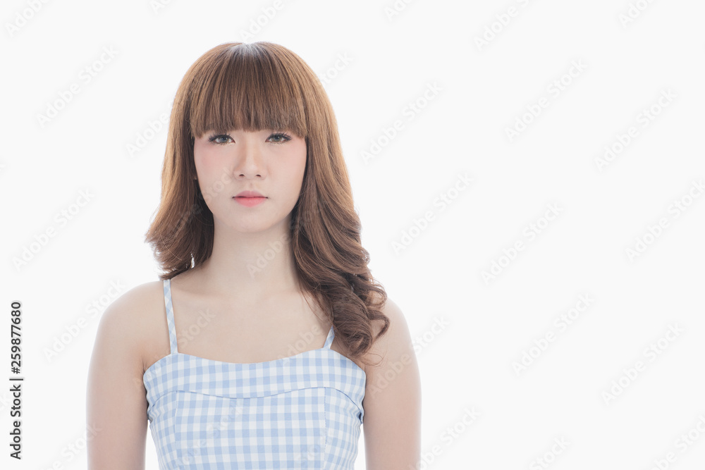 Front view close-up portrait of young beautiful Asian woman with curly long dark brown hair in light blue checked dress stand up straight and looking at camera on isolated white background Front view close-up portrait of young beautiful Asian woman with curly long dark brown hair in light blue checked dress stand up straight and looking at camera on isolated white background