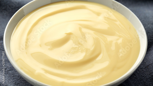 Fényképezés Bowl of vanilla custard on rustic background