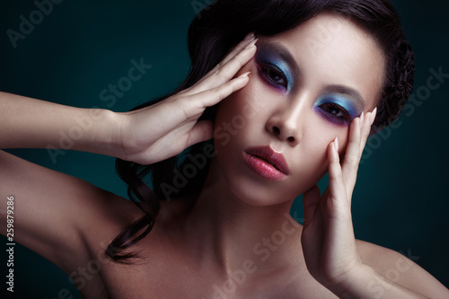 Beauty portrait of a sensual Asian girl with bright evening make-up.