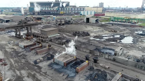 Aerial view of industrial railway station distribution point with train karts loaded with slag pots for the transportation of crude iron located at steelmaking factory producing steel from ore 4k photo