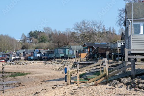 Maningtree Suffolk Uk - 1 April 2019: Row of large wooden beachside homes on beach