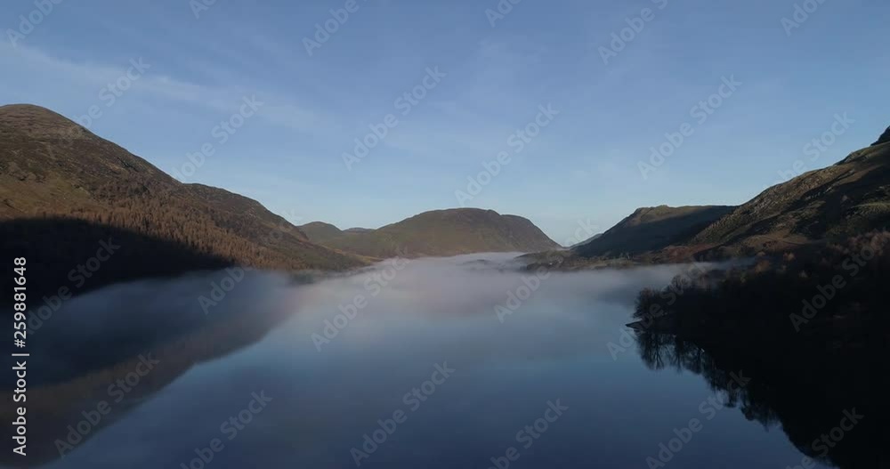 Aerial shot of flying over misty lake in the English lake district. Aerial shot of flying over misty lake in the English lake district.