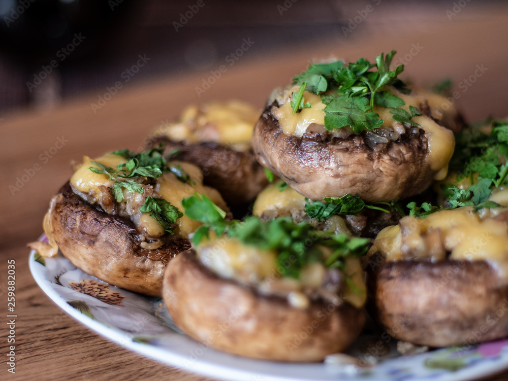 Stuffed mushrooms on a rough wooden surface Stuffed mushrooms on a rough wooden surface