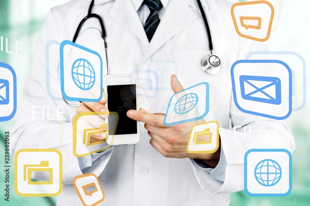Close-up of male Doctor pointing at smartphone Close-up of male Doctor pointing at smartphone