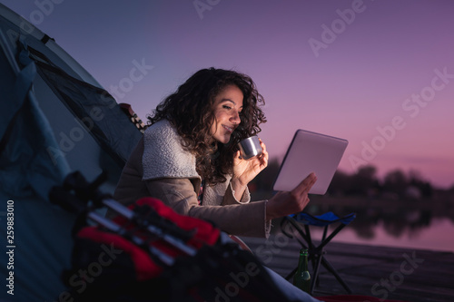 Woman camping by the lake