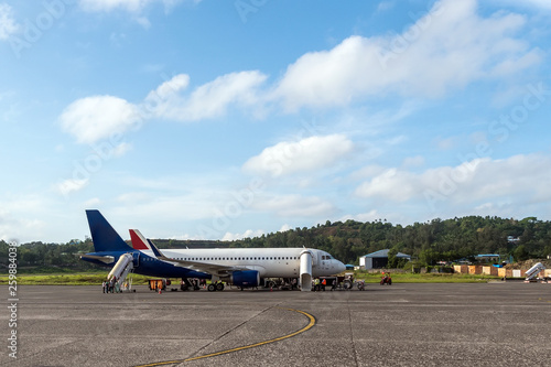 Passenger airliner stands on the runway of the airport photo