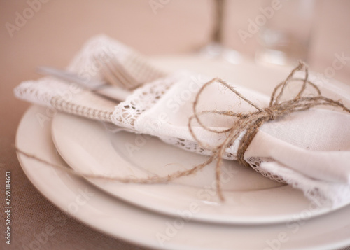 Elegant restaurant table setting for fine dining with plates cutlery and stemware