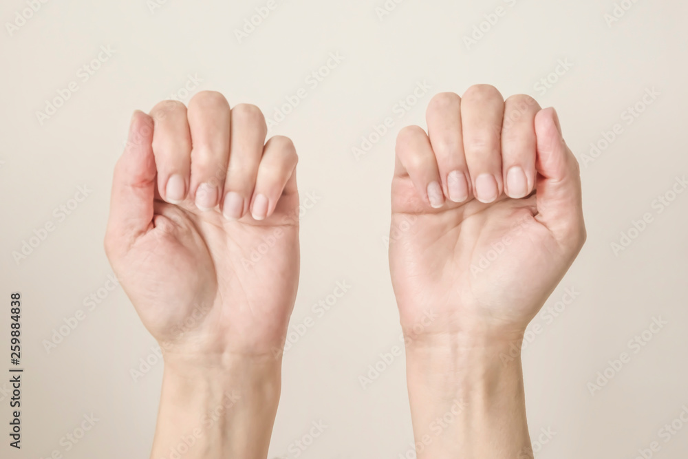 female hands with folded fingers showing nails female hands with folded fingers showing nails