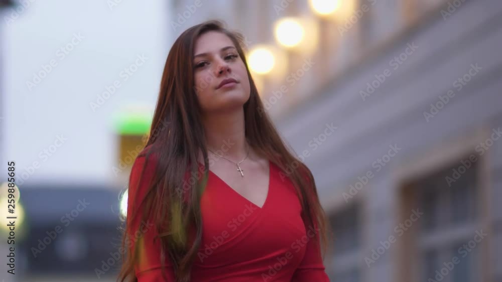 Young woman outside on the street is looking Young woman outside on the street is looking