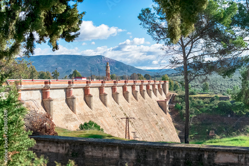 View of the great dam of the Guadalen reservoir with its reddish colors, a historical work. Photograph taken in the province of Jaen, Spain photo