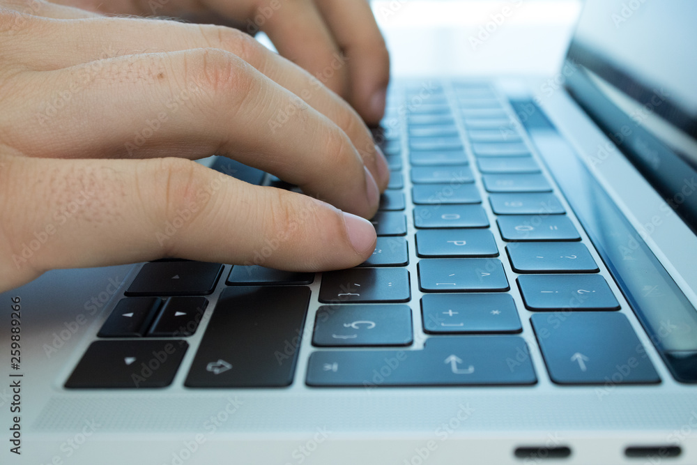 Business person using the keyboard of a laptop on a white table. Person working. Business person using the keyboard of a laptop on a white table. Person working.