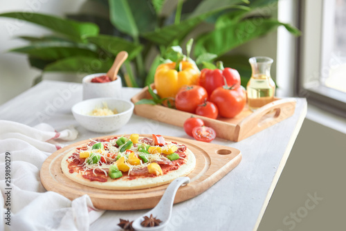 Raw pizza dough with tomato sauce  ingredients