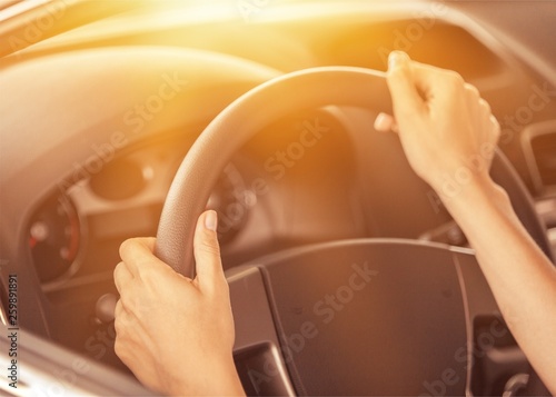 Businessman driving his car on background. Close-up human hand holding gear shift knob © BillionPhotos.com