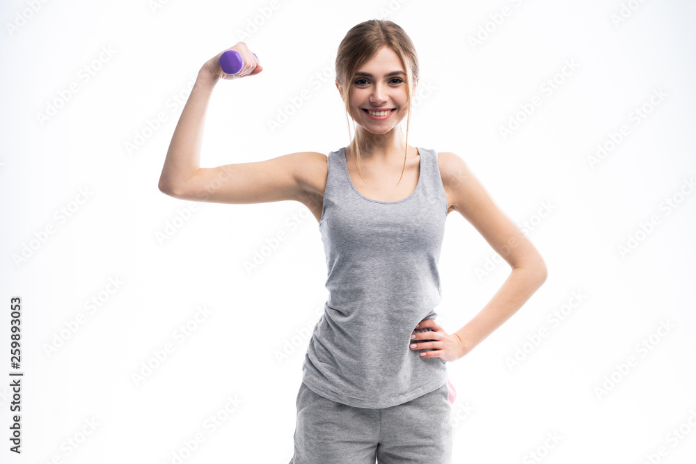 Portrait of pretty sporty girl holding weights dumbbells and make exercises on white background. Portrait of pretty sporty girl holding weights dumbbells and make exercises on white background.