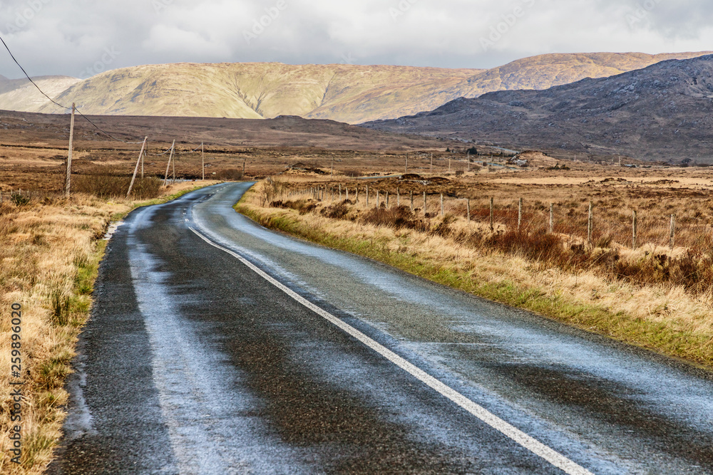 Conemara road with bog and mountains in background Conemara road with bog and mountains in background