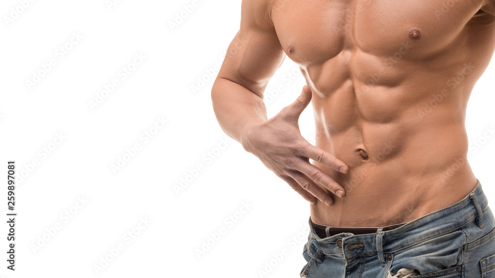 Muscular male torso isolated on white. Shirtless man in blue jaens touching his abs