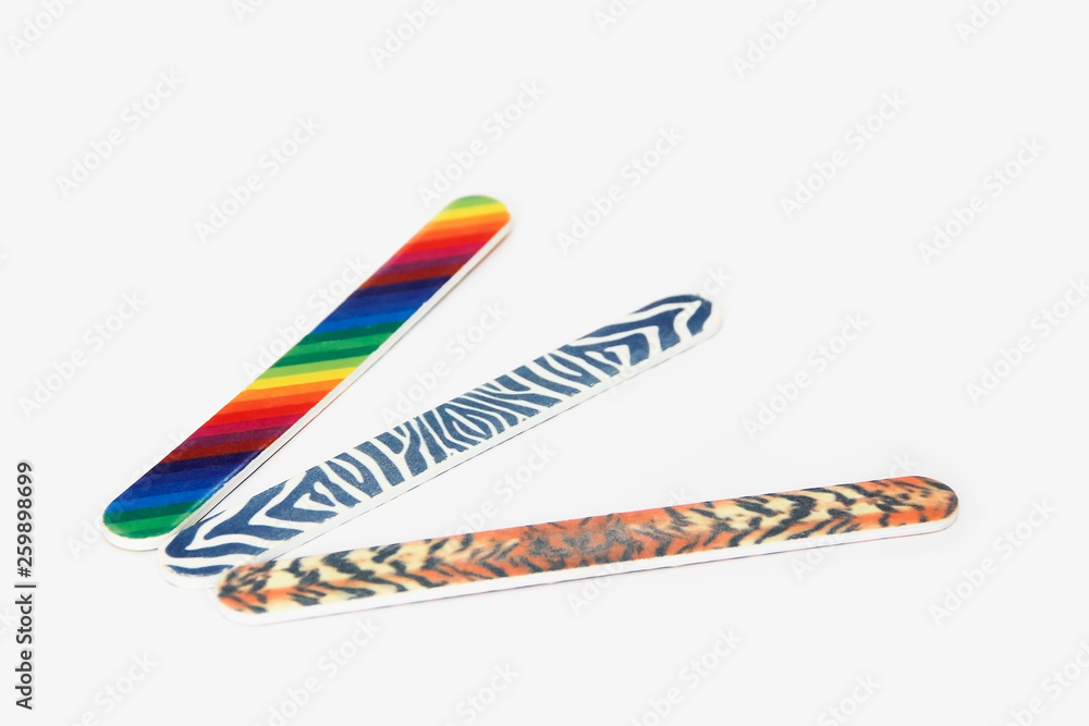 Multicolored used pedicure manicure nail files on white isolated background Multicolored used pedicure manicure nail files on white isolated background