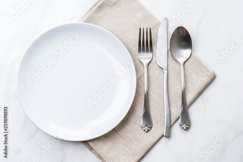 empty plate spoon fork and knife