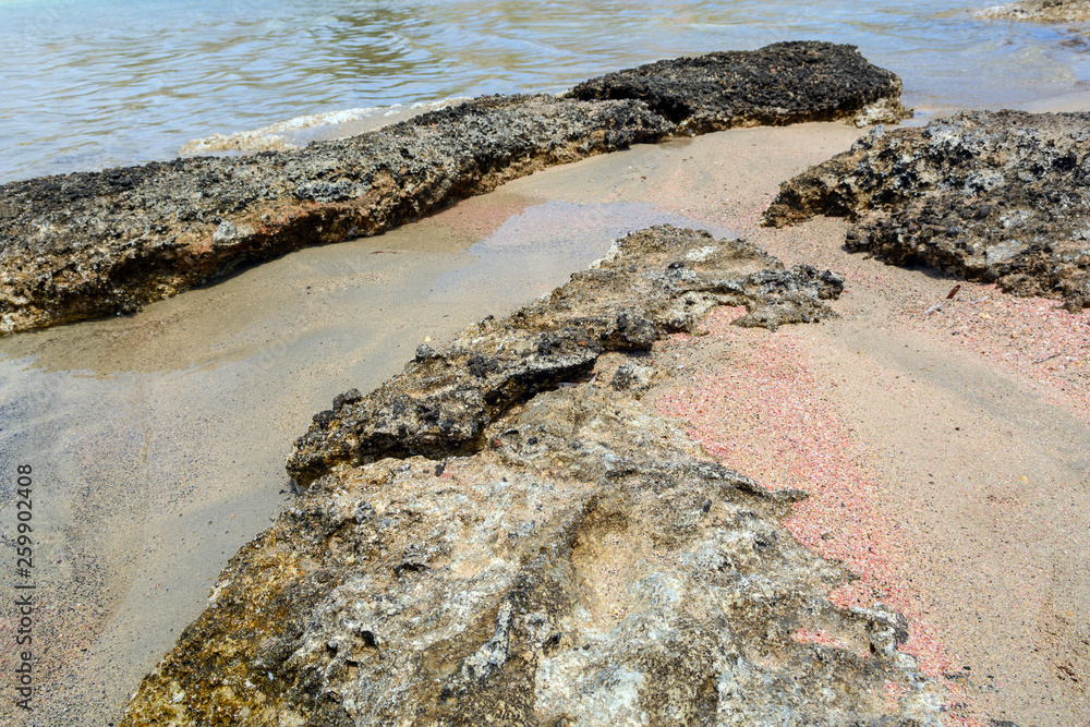 Fototapeta premium Elafonisi beach with rocks, pink sand, warm and crystal clear water. Crete Island, Greece