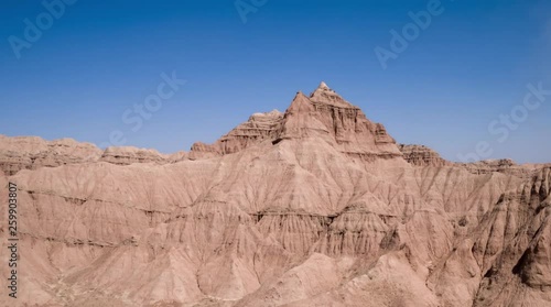 Aerial flight in the desert over sharp sandy cliffs, mountains. Panoramic view. Iran.
