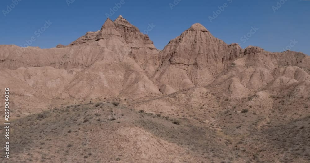 Aerial flight in the desert over sharp sandy cliffs, mountains. Panoramic view. Iran. Aerial flight in the desert over sharp sandy cliffs, mountains. Panoramic view. Iran.