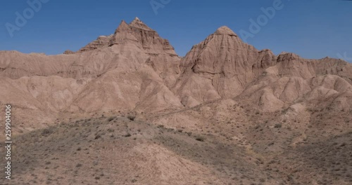 Aerial flight in the desert over sharp sandy cliffs, mountains. Panoramic view. Iran.
