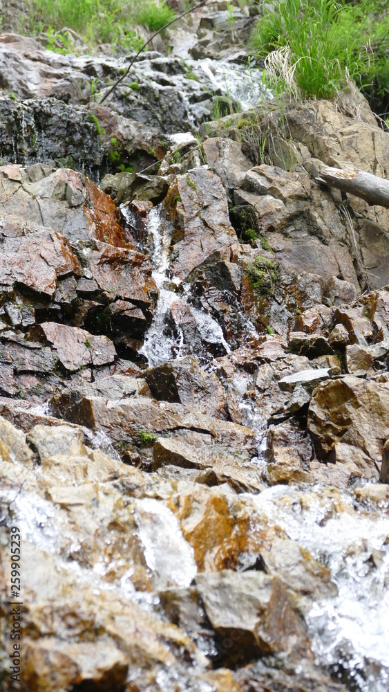 Waterfall among stones and rocks