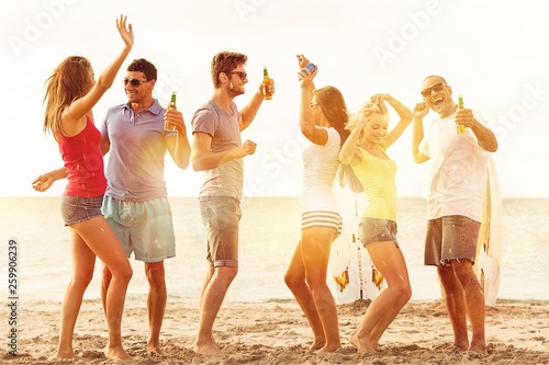 Group of young adults partying at the beach