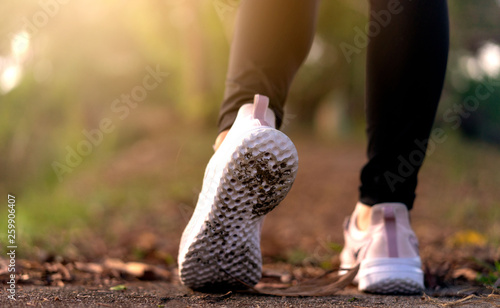 Female hands tying shoelace on running shoes before practice.Runner getting ready for training. Sport active lifestyle concept.Close-up.Horizontal photo banner for website header design