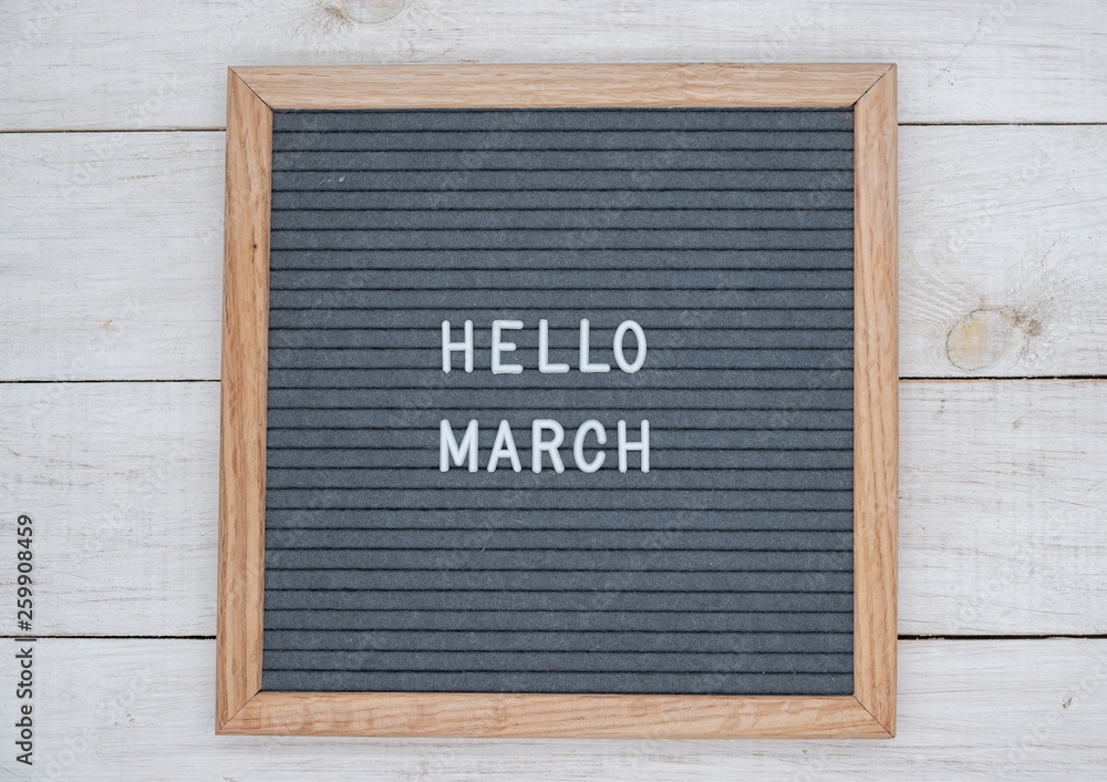 English text Hello March on a letter Board in white letters on a gray background