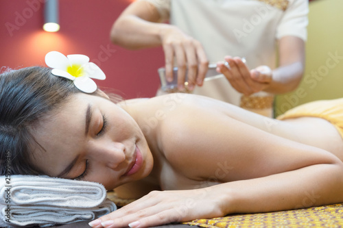 Beautiful young woman in spa salon.Relaxed woman lying on spa bed for facial and head massage spa treatment by massage therapist in a luxury spa.selective focus