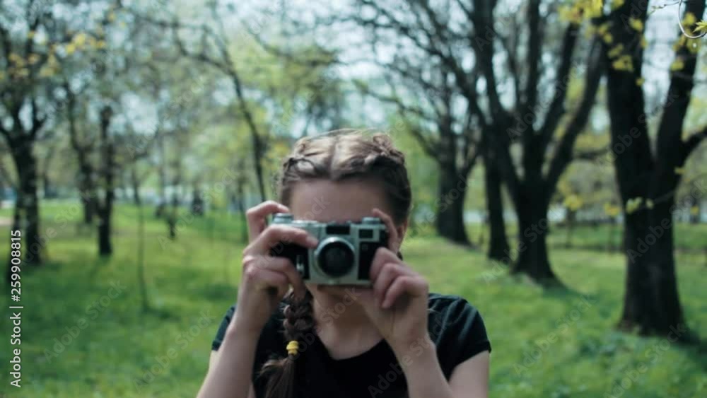 woman make a photo of blossom apple tree in the part at spring. woman make a photo of blossom apple tree in the part at spring.