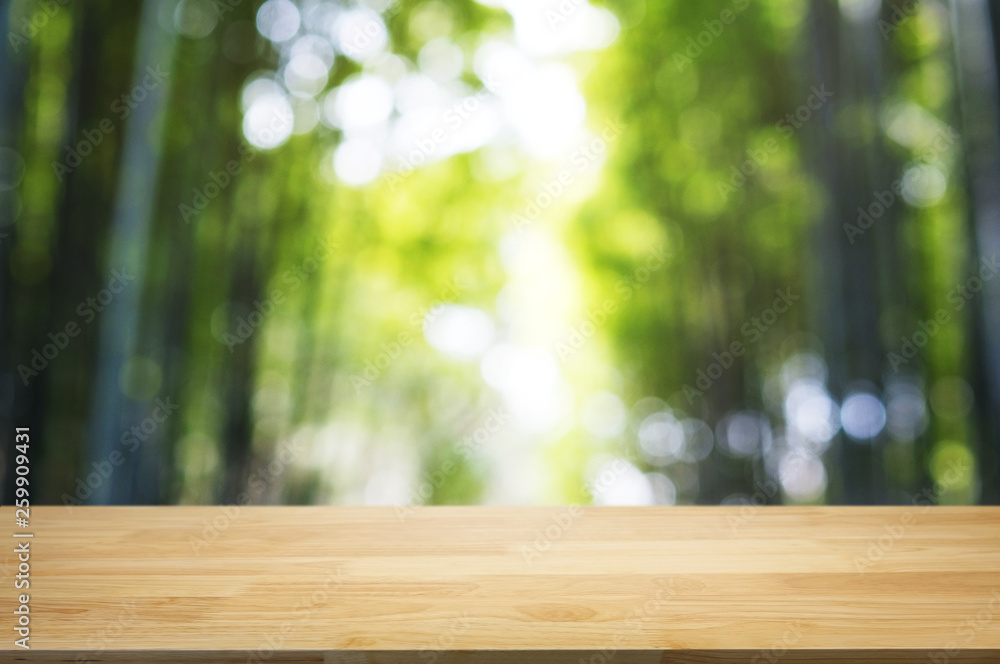 empty wood table top over blur outdoor green nature background. empty wood table top over blur outdoor green nature background.