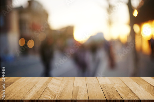 empty wooden deck, table top over blur outdoor market background.