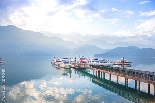 boat and speed boat pier in sunrise morning at Sun moon lake , taiwan