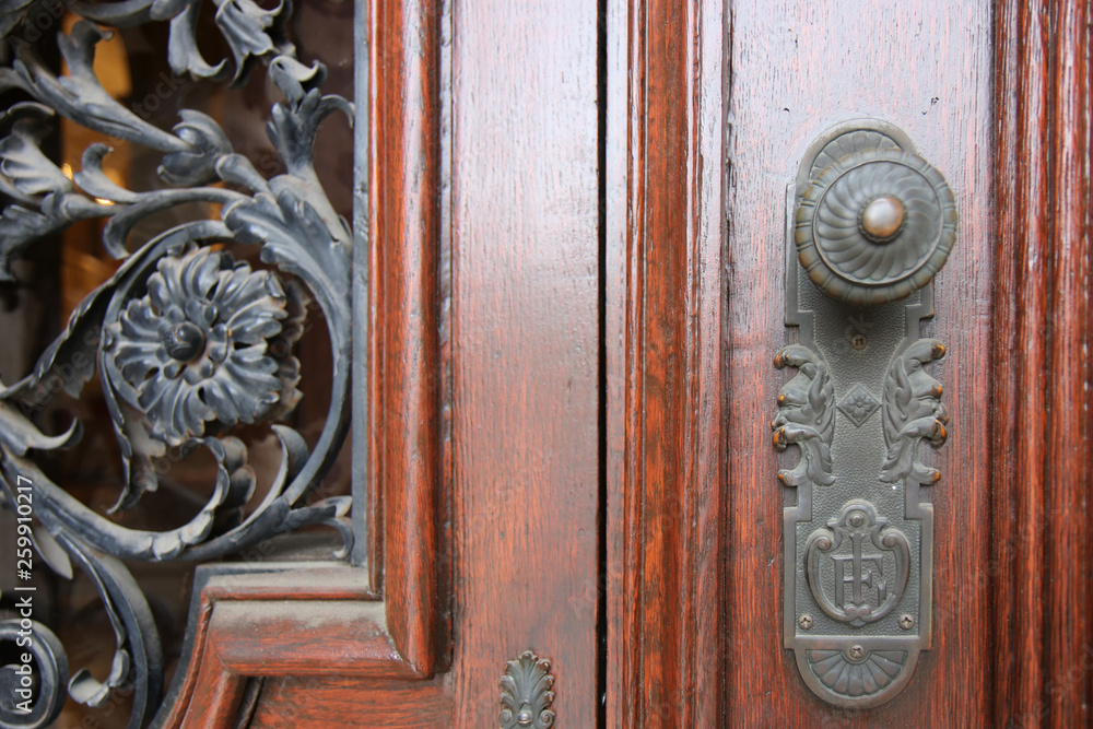The Modern wooden door with metal door handle over the white wall. -Image The Modern wooden door with metal door handle over the white wall. -Image
