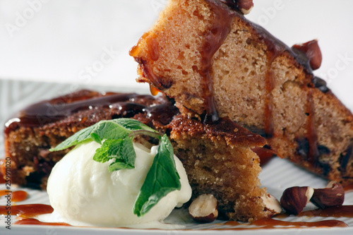 Slice of chocolate cake with vanilla ice cream, caramel and mint. photo