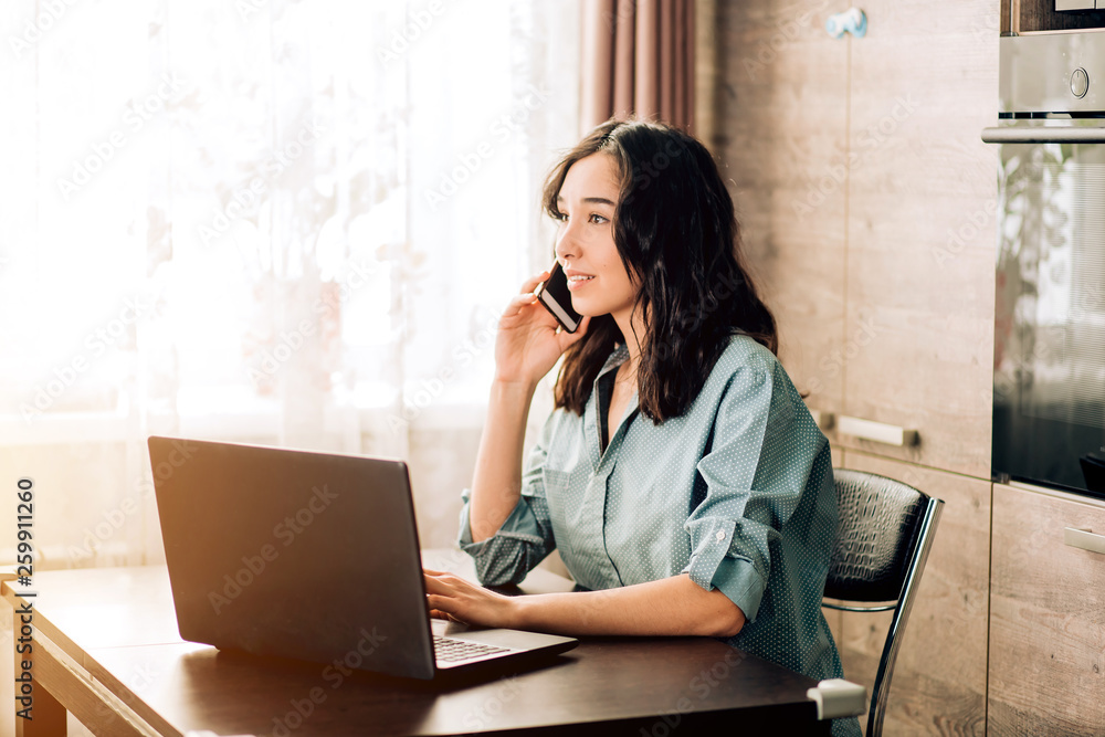Happy young woman using laptop at home Happy young woman using laptop at home