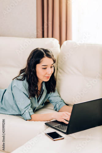 Bbeautiful woman using laptop computer at home on sofa