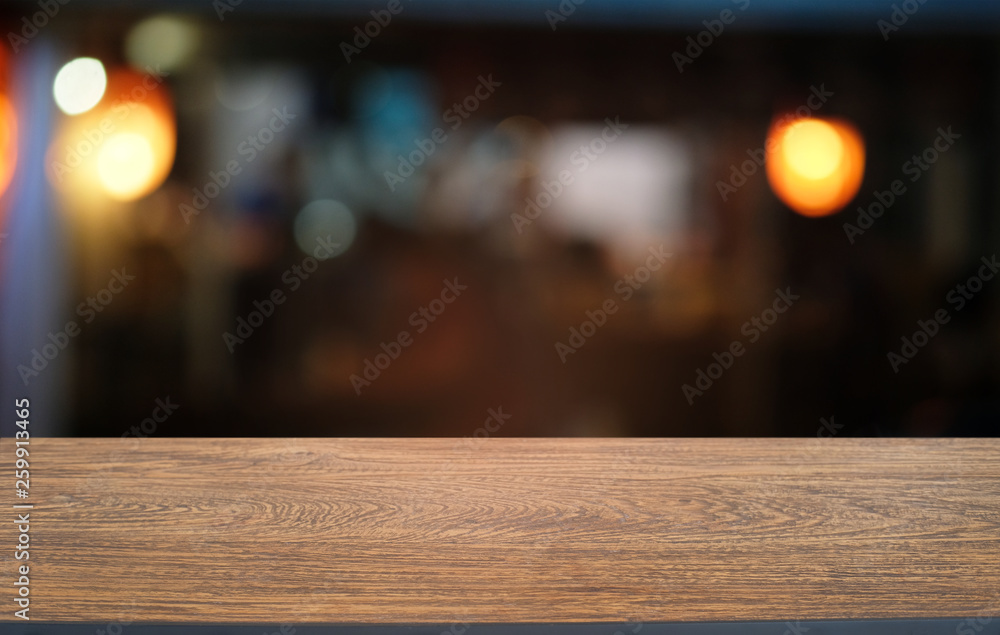 Empty dark wooden table in front of abstract blurred bokeh background of restaurant . can be used for display or montage your products.Mock up for space. Empty dark wooden table in front of abstract blurred bokeh background of restaurant . can be used for display or montage your products.Mock up for space.