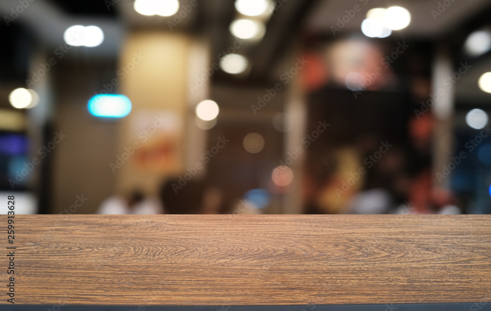 Empty dark wooden table in front of abstract blurred bokeh background of restaurant . can be used for display or montage your products.Mock up for space. Empty dark wooden table in front of abstract blurred bokeh background of restaurant . can be used for display or montage your products.Mock up for space.
