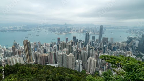 HONG KONG, CHINA - APRIL 2, 2019: 4K Cinematic Zooming In Time Lapse Footage of Victoria Harbour taken from The Peak in Hong Kong during cloudy day.