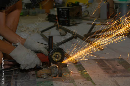 Electric wheel grinding cuting on steel. sparks from cutting
